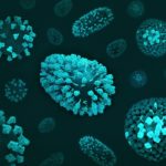 a group of blue and green cells on a black surface